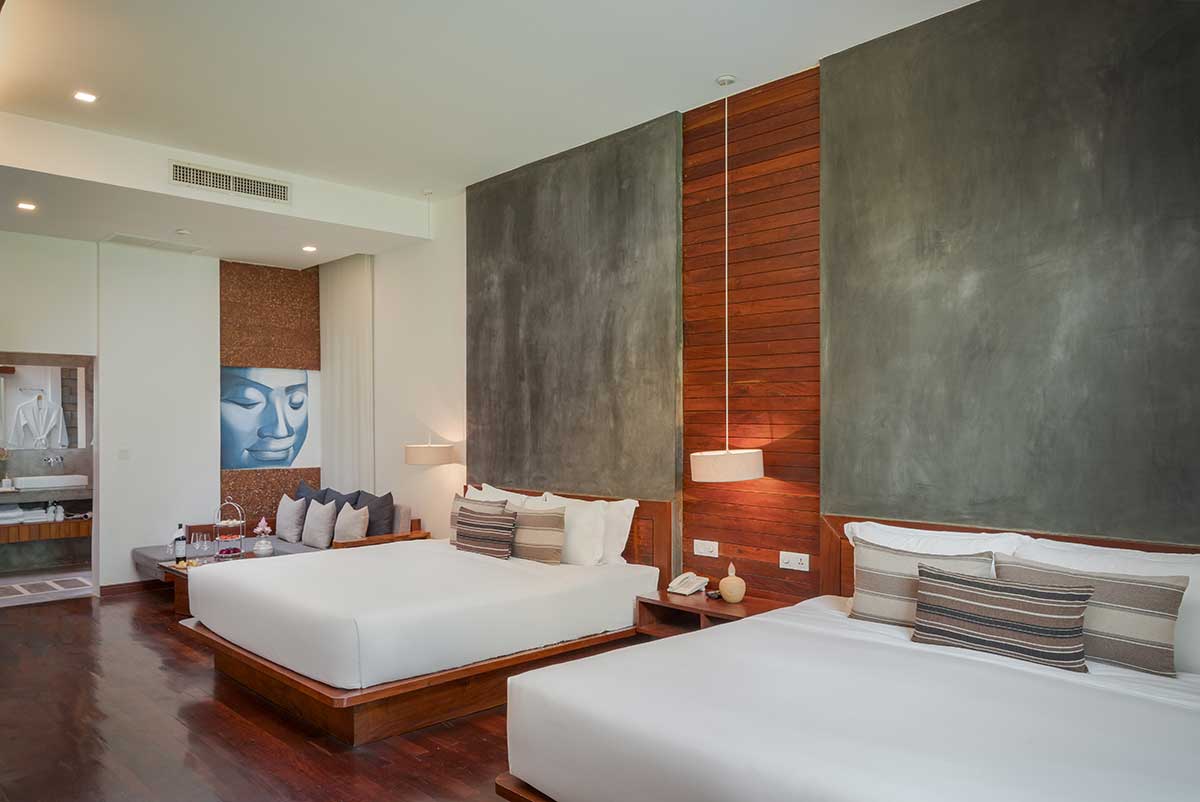 Spacious Family Suite at Shintana Saya Residence Siem Reap with two king-sized beds and a private lounge area.