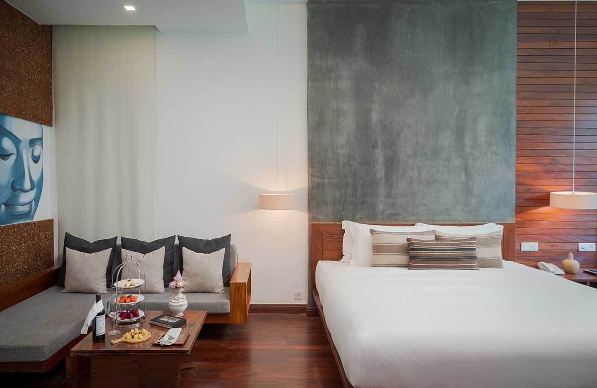 Family Suite at Shintana Saya Residence Siem Reap featuring a king bed and lounge with afternoon tea.
