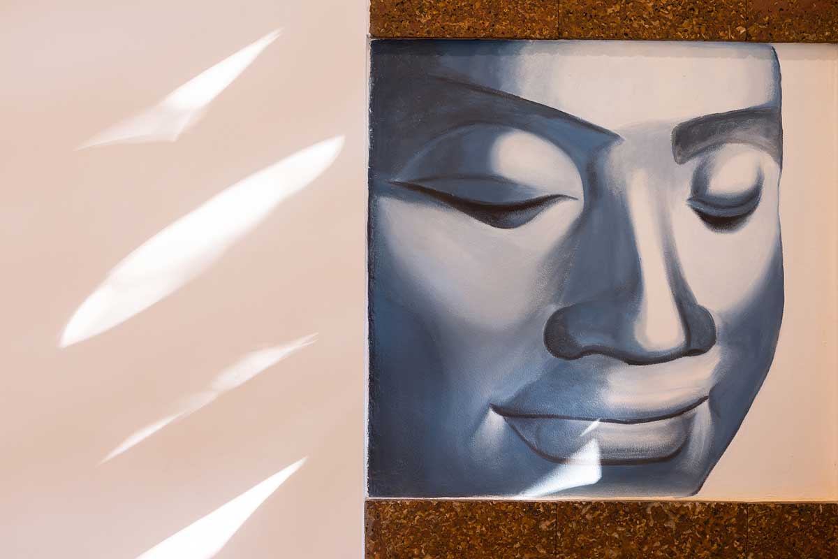 Close-up of a serene Buddha wall mural in the Family Suite at Shintana Saya Residence Siem Reap.