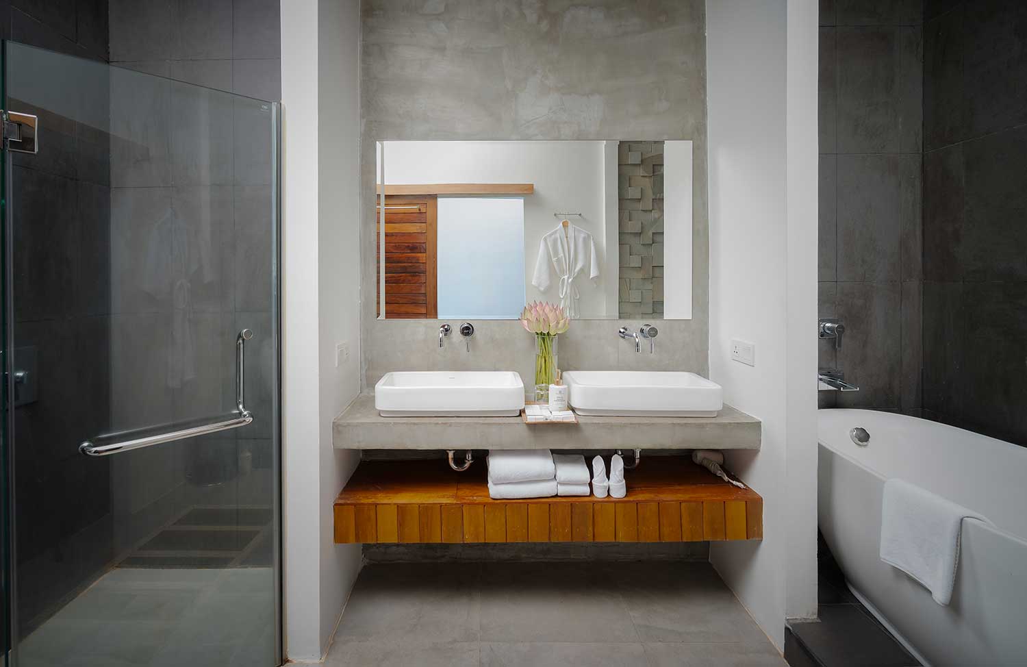 Luxury en-suite bathroom double sink vanity with stone wall accents.
