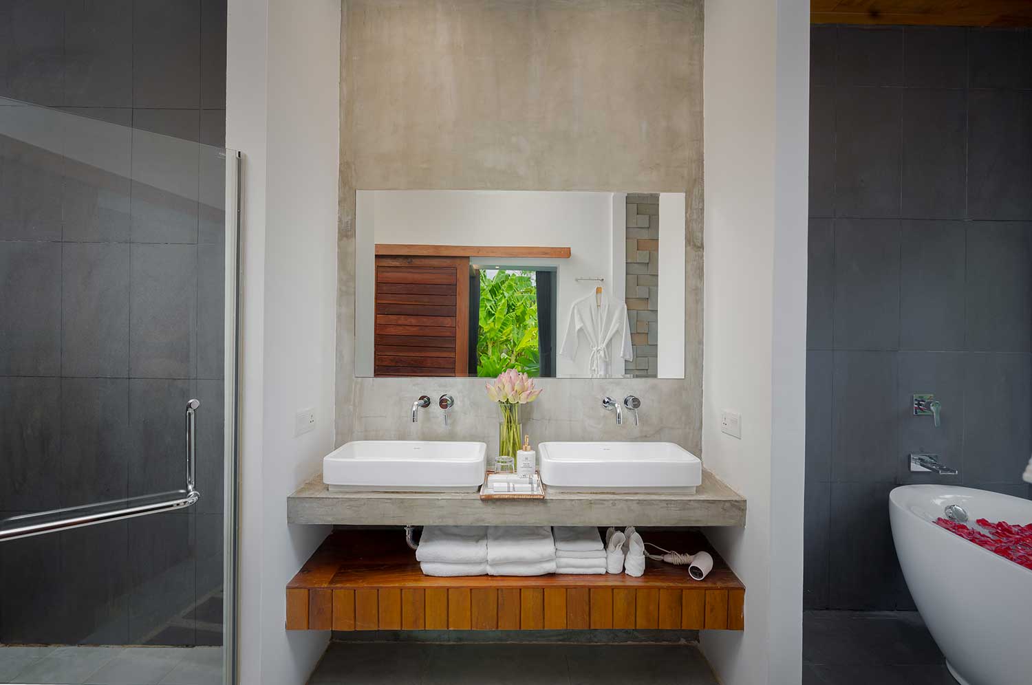 Modern double vanity with white vessel sinks and wooden storage in a Premium Room.