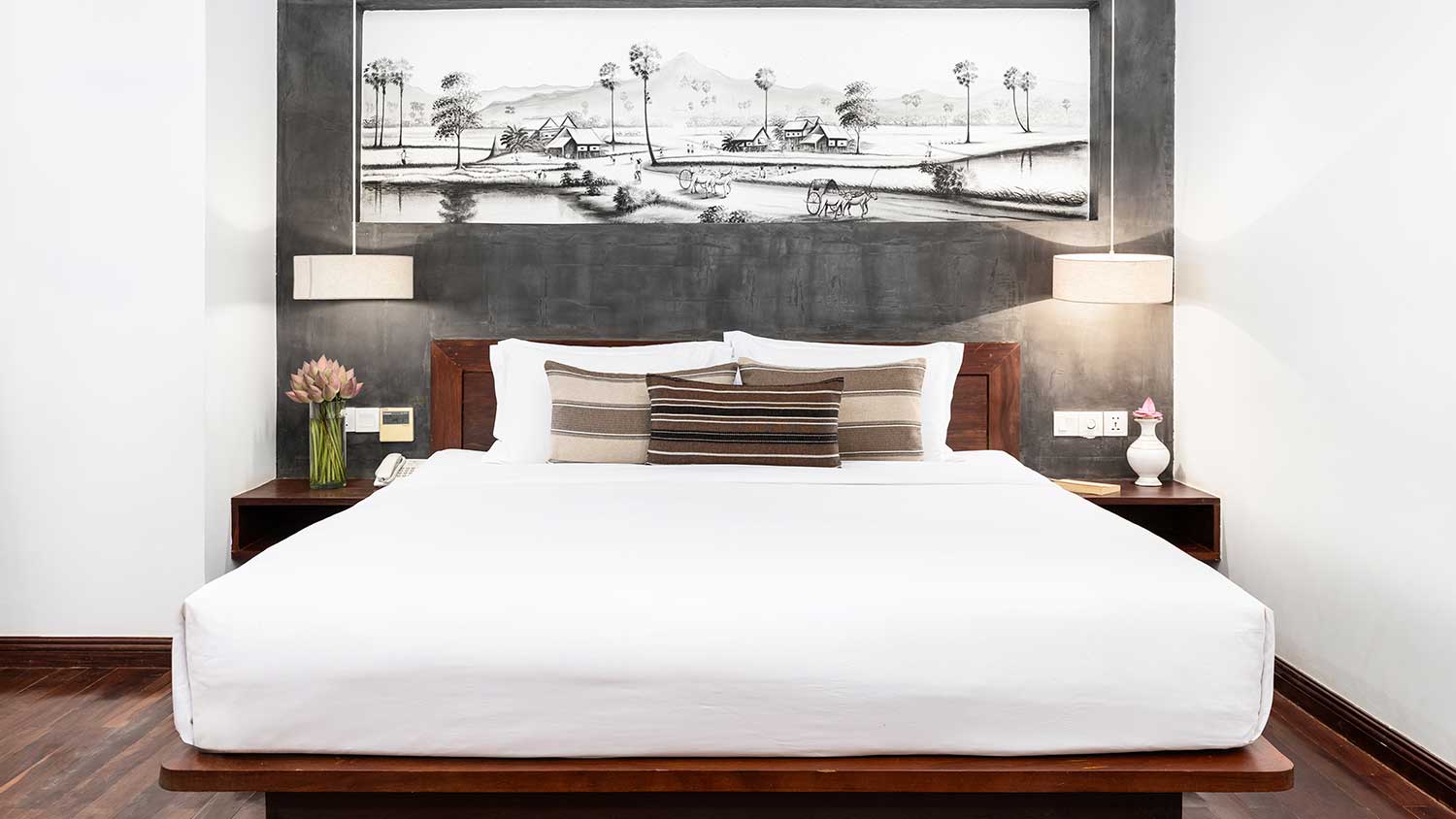 Close-up of luxury bedding and decorative pillows in the Royal Suite at Shintana Saya Residence.