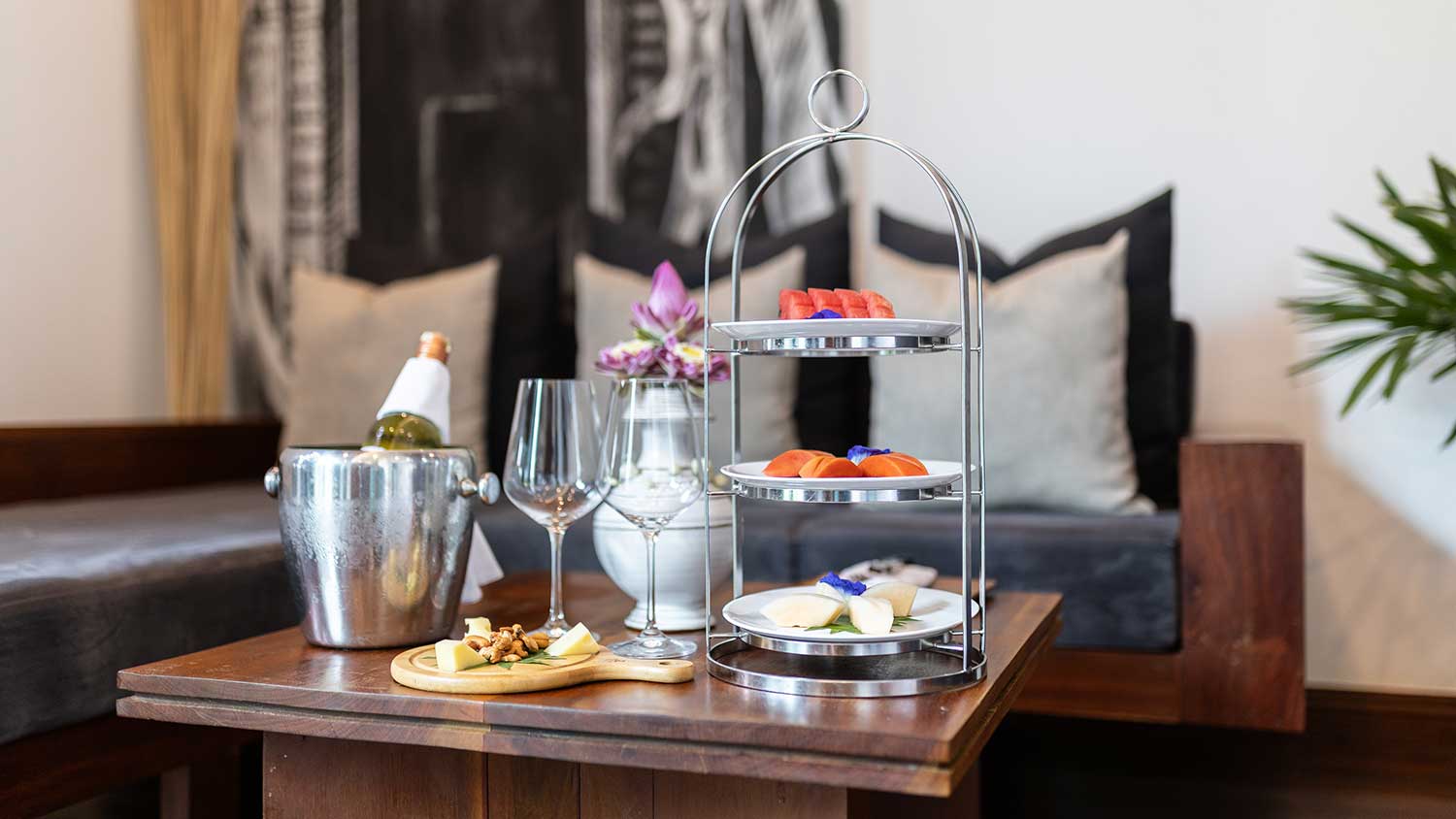 Royal Suite living area at Shintana Saya Residence Siem Reap featuring a 3-tier high tea set and champagne.