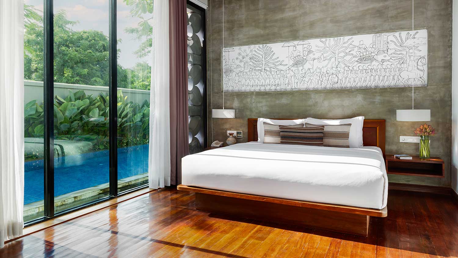 Royal Two-Bedroom Family Suite at Shintana Saya Residence Siem Reap with pool view and floating king bed.