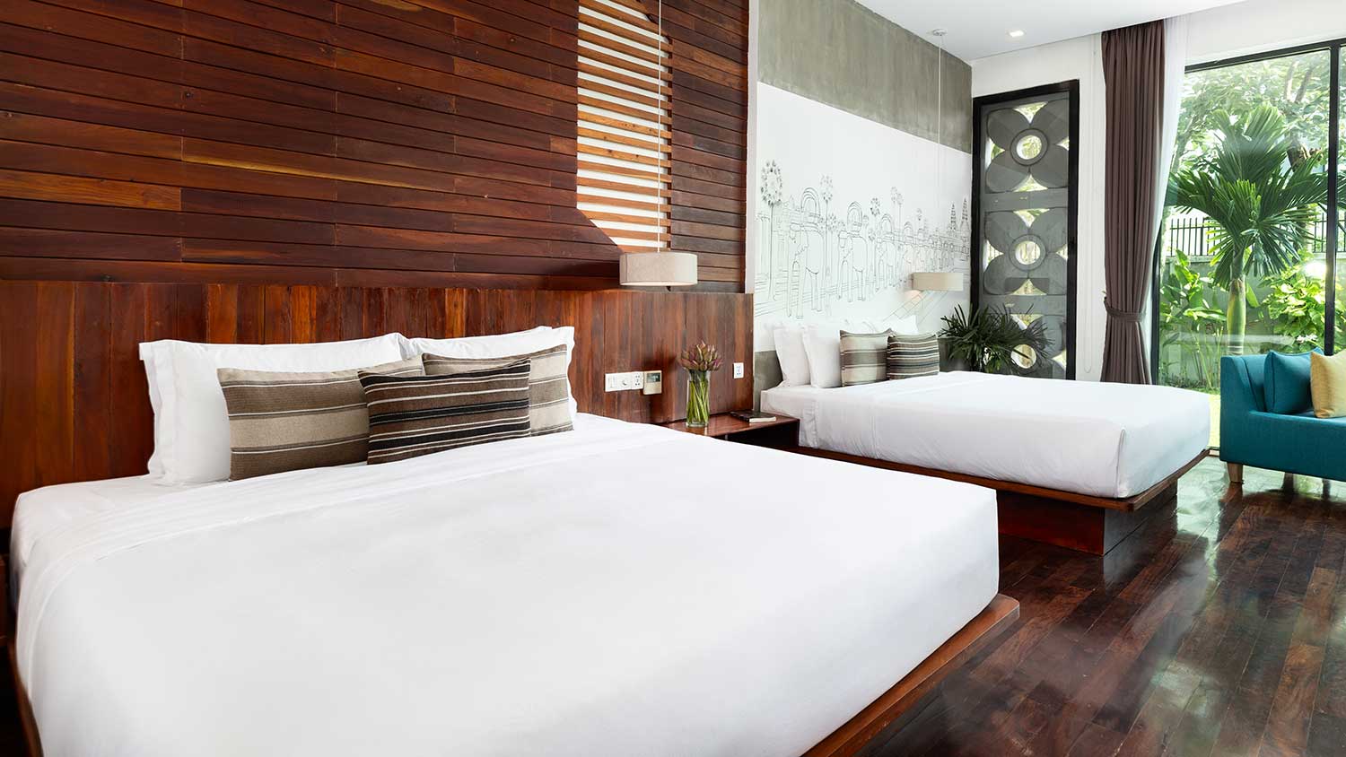 Royal Two-Bedroom Family Suite at Shintana Saya Residence Siem Reap with twin beds and a private garden view.